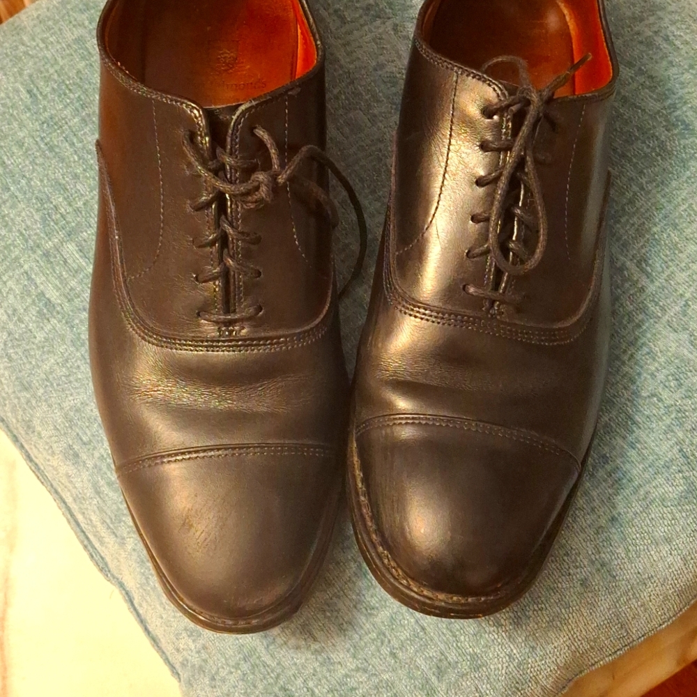 Comfortable shoes worn with a small tear on the front and little wear on the bot